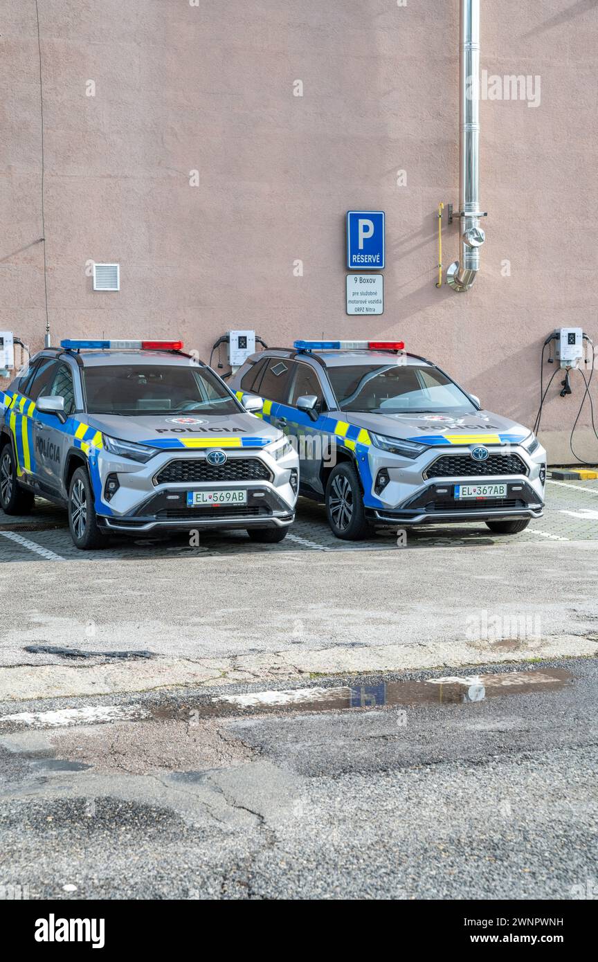 Nitra, Slovacchia - 24 febbraio 2024: Auto elettriche della polizia Toyota che si caricano presso la stazione di ricarica EV o apparecchiature di alimentazione per veicoli elettrici (EVSE). Foto Stock