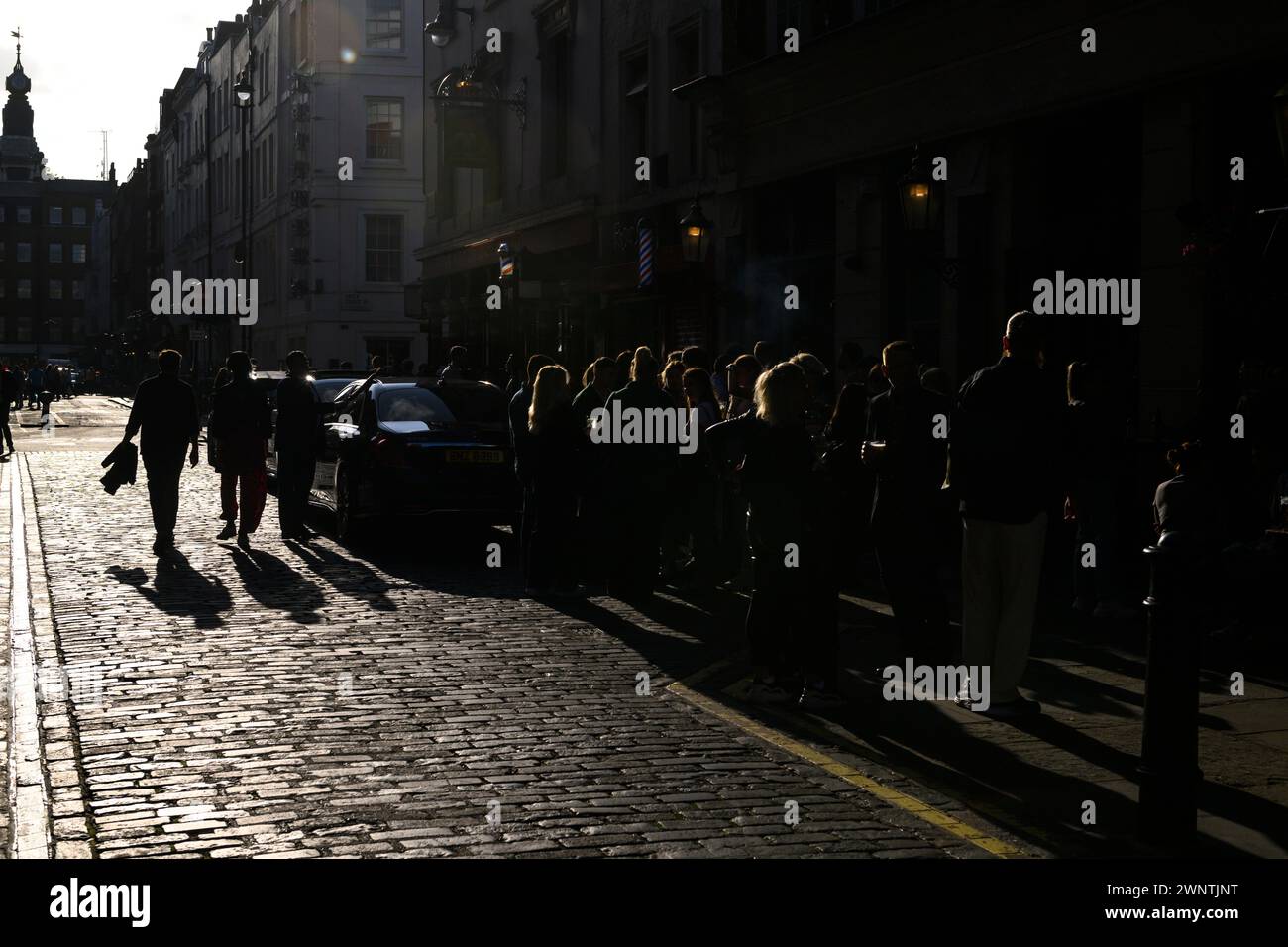 Fuori dal Coach and Horses Pub sono pedoni e bevitori al sole del pomeriggio. Romilly Street, Soho, Londra, Regno Unito. 29 settembre 2023 Foto Stock