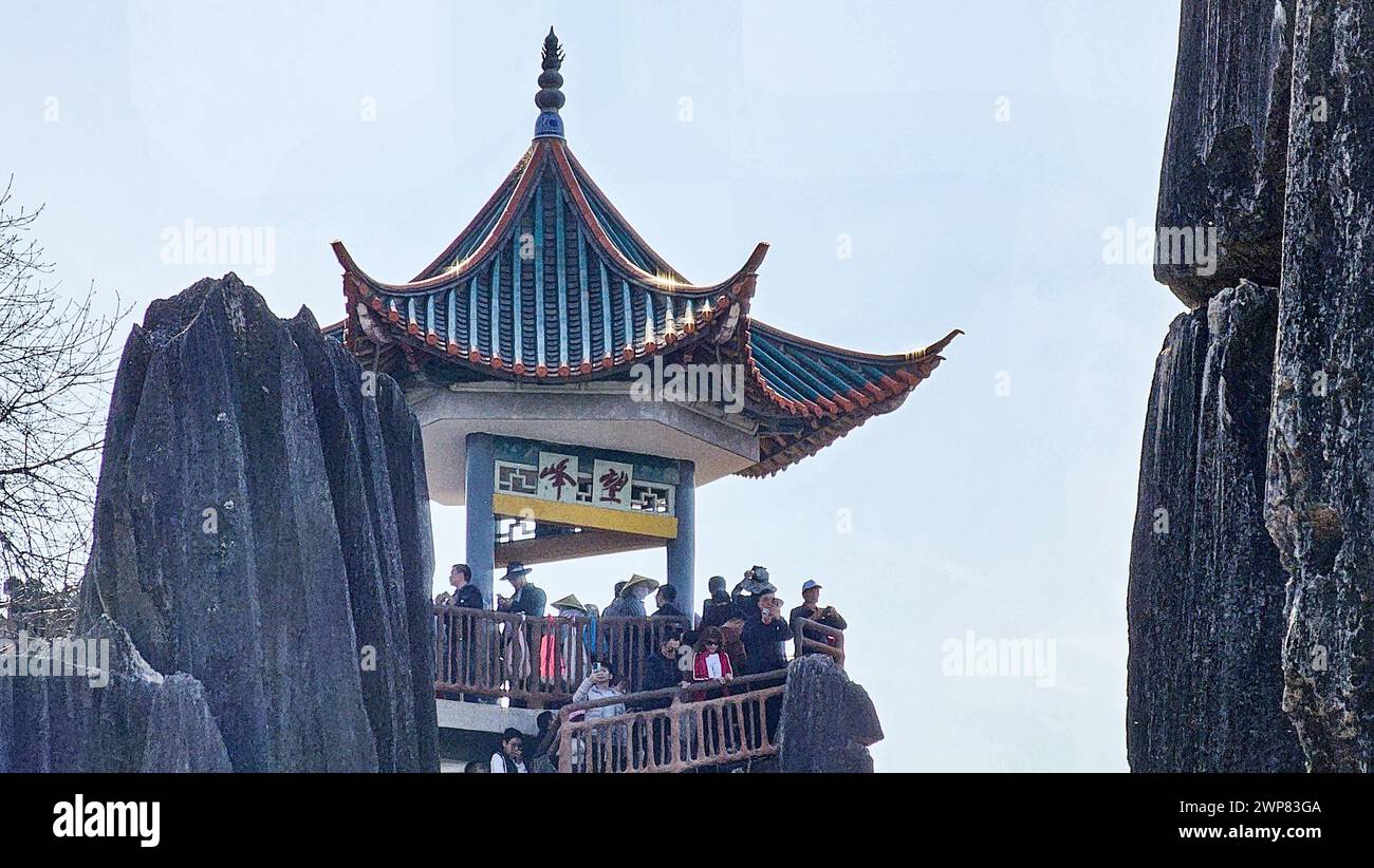 Un gruppo di individui in piedi su una pagoda nella Foresta di pietra di Shilin in Cina Foto Stock