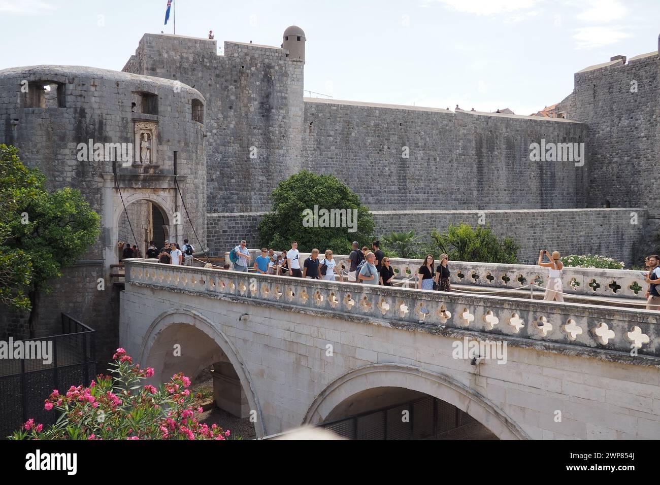 Pile Gate Dubrovnik Croazia 14 agosto 2022 persone uomini e donne camminano lungo il ponte di pietra fino al cancello della città Vecchia. Una folla di turisti. Occupato Foto Stock