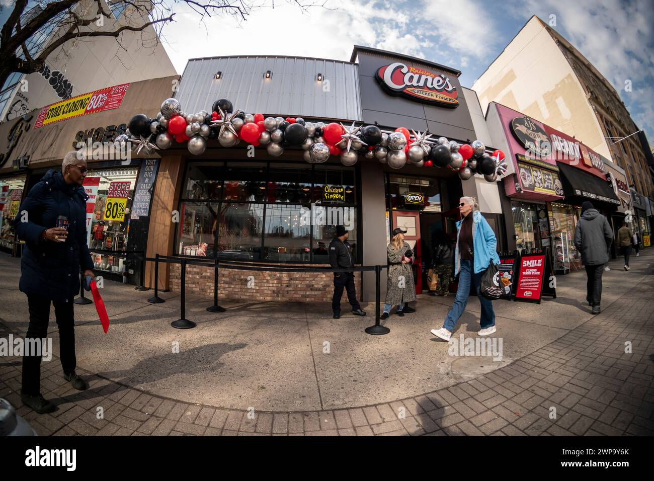 Orde di amanti del dito di pollo affluiscono alla grande apertura del nuovo negozio di Raising cane ad Harlem, New York, martedì 27 febbraio 2024. La catena di fast food con sede in Louisiana serve solo finger food di pollo con contorni di accompagnamento e prevede di aprire 25 sedi a New York City entro i prossimi tre anni. La catena ha oltre 740 ristoranti in 36 stati, il Medio Oriente e il territorio di Guam. (© Richard B. Levine) Foto Stock