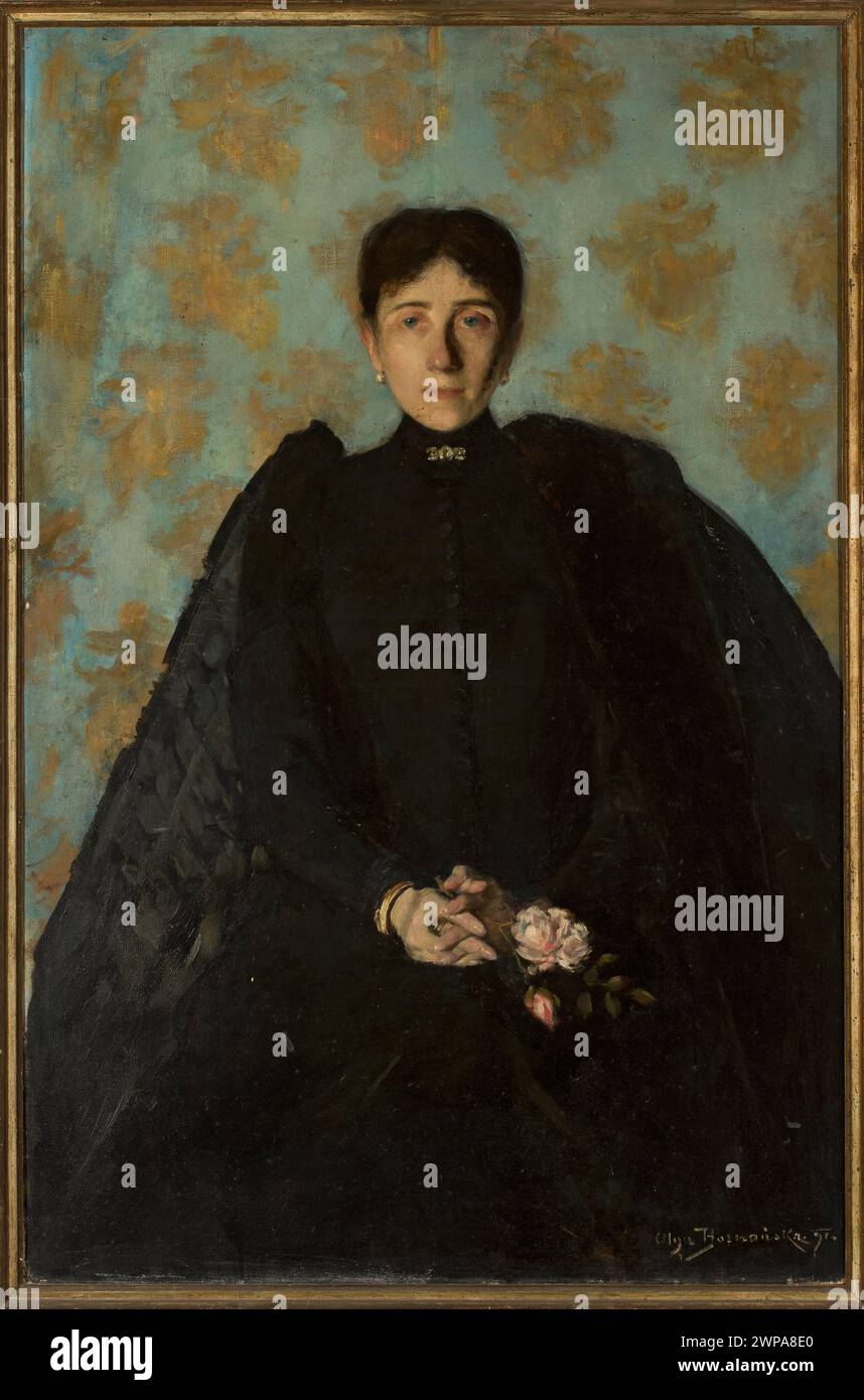 Ritratto ad olio di una donna di Olga Boznańska (1865-1940), dipinto nel 1891. Il soggetto indossa un abito nero con gioielli ed è adagiato su uno sfondo floreale e arazzo. Creato in stile giovane Polonia, il dipinto enfatizza la ritrattistica femminile en face. Foto Stock