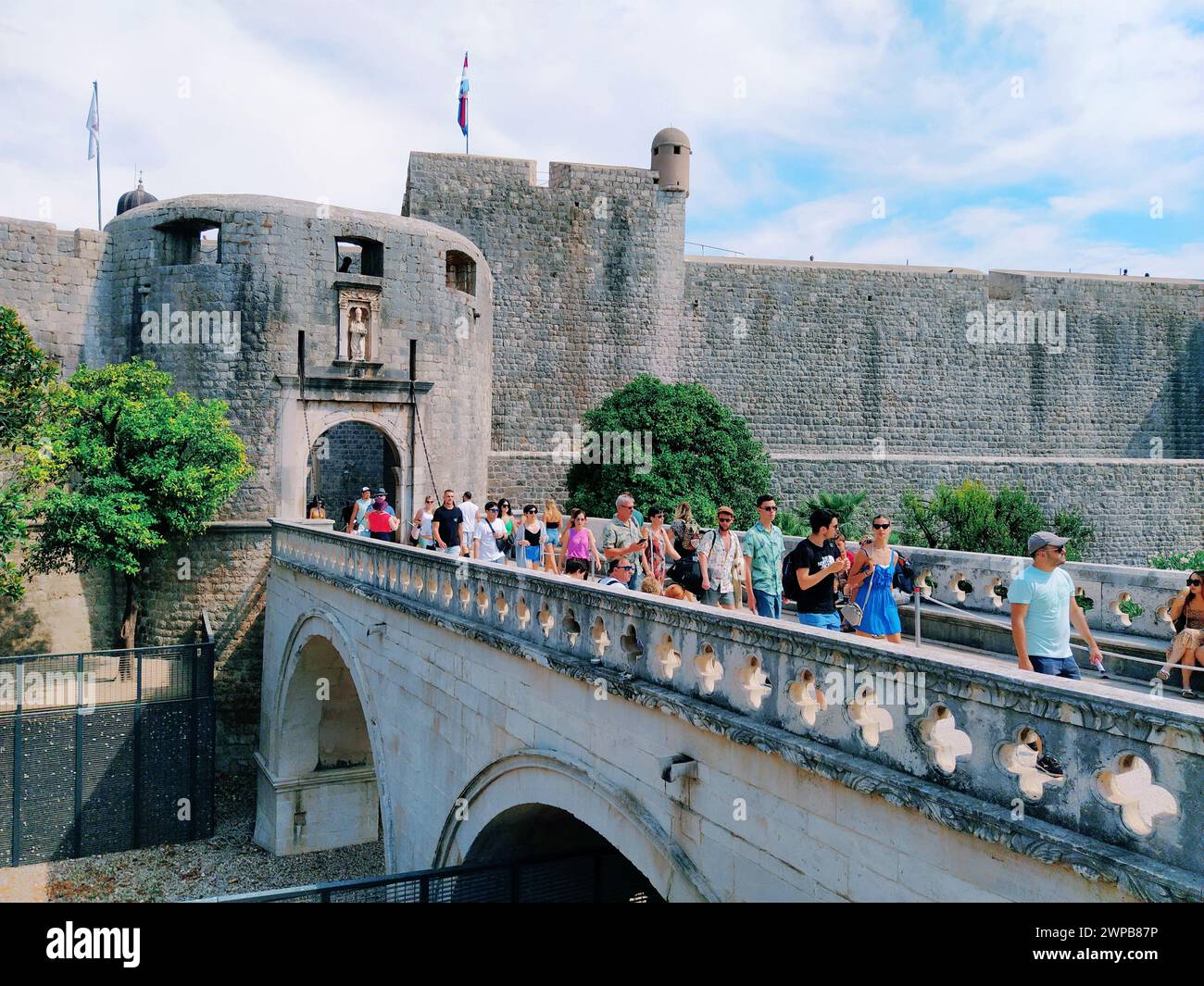Pile Gate Dubrovnik Croazia 14 agosto 2022 persone uomini e donne camminano lungo il ponte di pietra fino al cancello della città Vecchia. Una folla di turisti. Occupato Foto Stock
