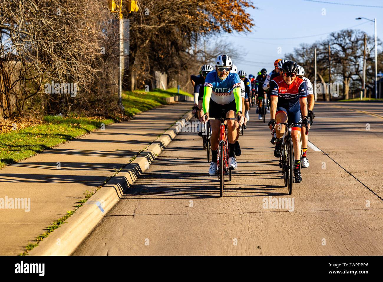 Un gruppo di individui che pedalano per una strada cittadina in bicicletta ad Arlington, Stati Uniti Foto Stock