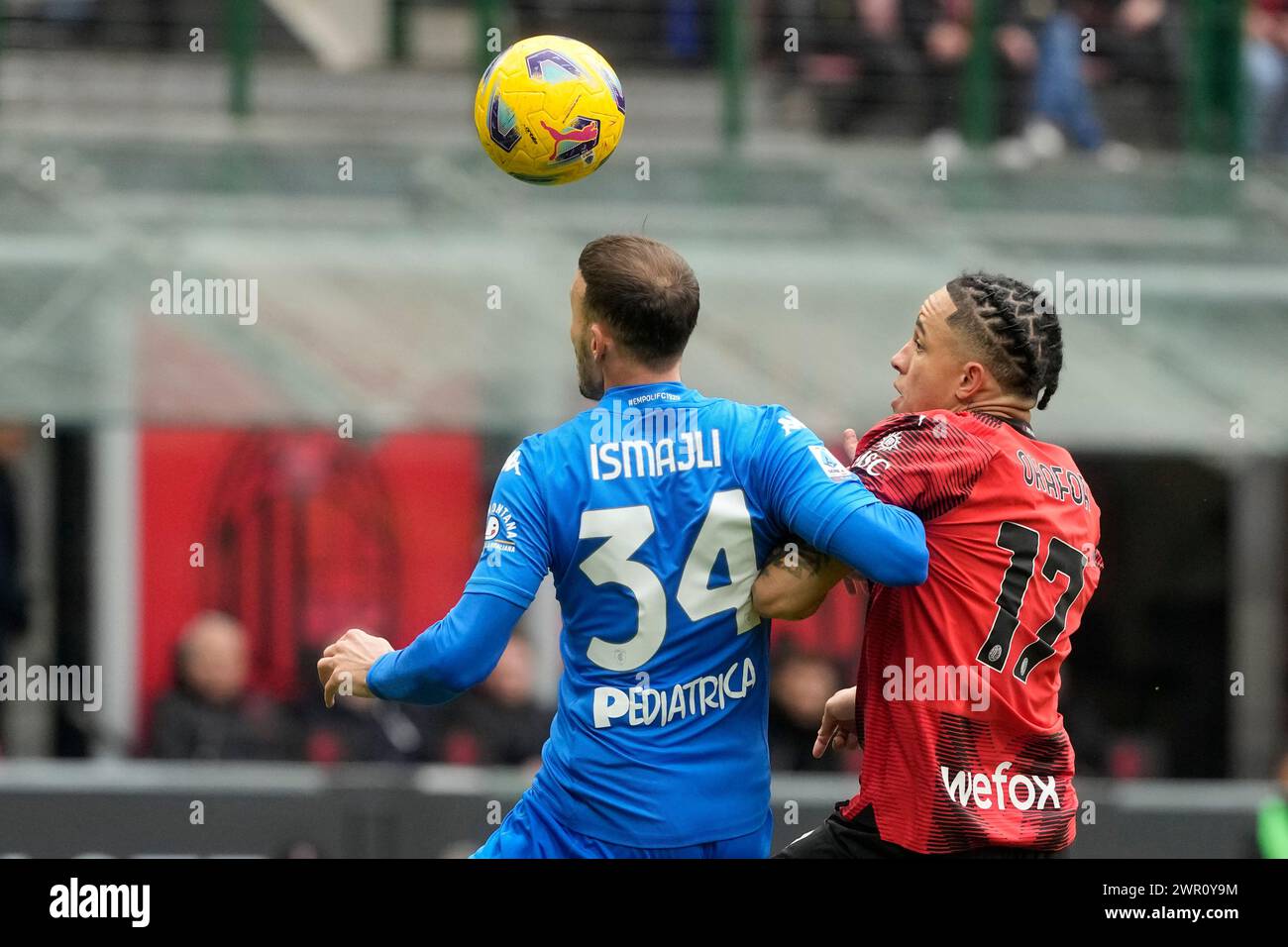AC Milan's Noah Okafor, right, challenges for the ball with Empoli's Ardian Ismajli during a Serie A soccer match between AC Milan and Empoli at the San Siro stadium in Milan, Italy, Sunday, March 10, 2024. (AP Photo/Luca Bruno) Foto Stock