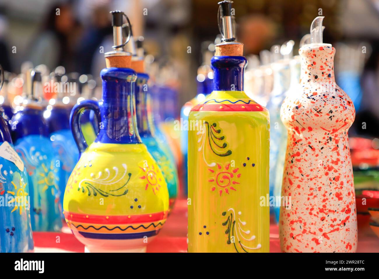 Diversi tipi di lattine di olio colorate fatte a mano esposte in un mercato di strada Foto Stock