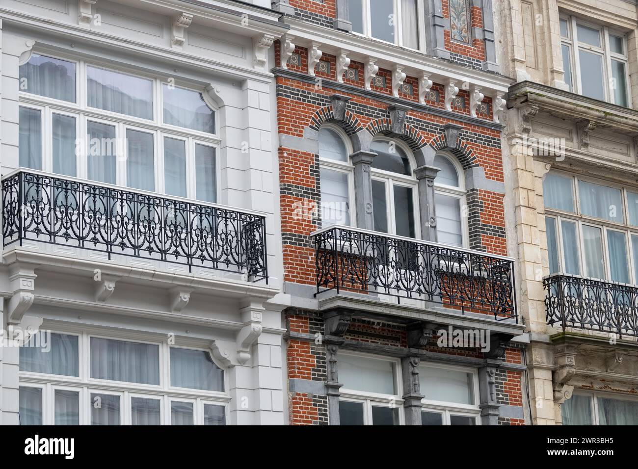 Vista dettagliata di una facciata in mattoni dal design classico con cornici bianche delle finestre, Blankenberge, Fiandre, Belgio Foto Stock