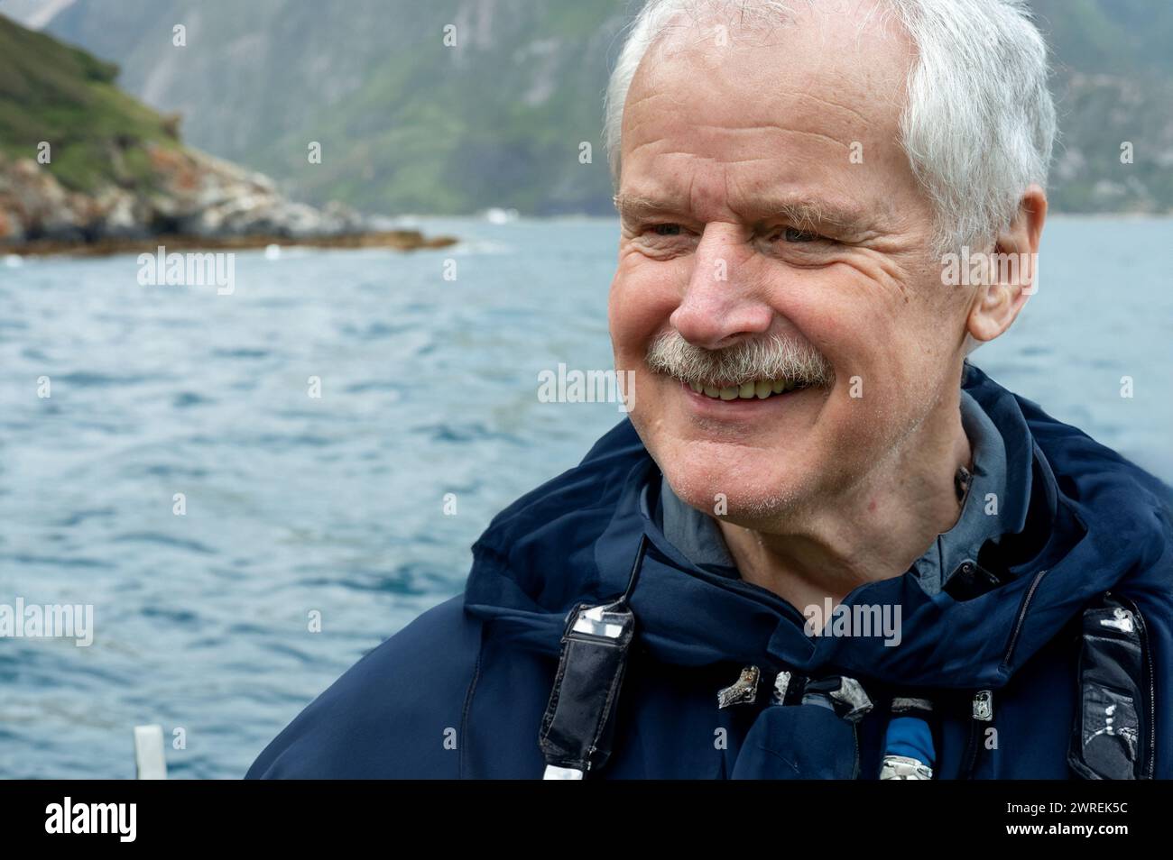 Buon anziano che si gode la pensione nella natura a bordo di una barca. Foto Stock