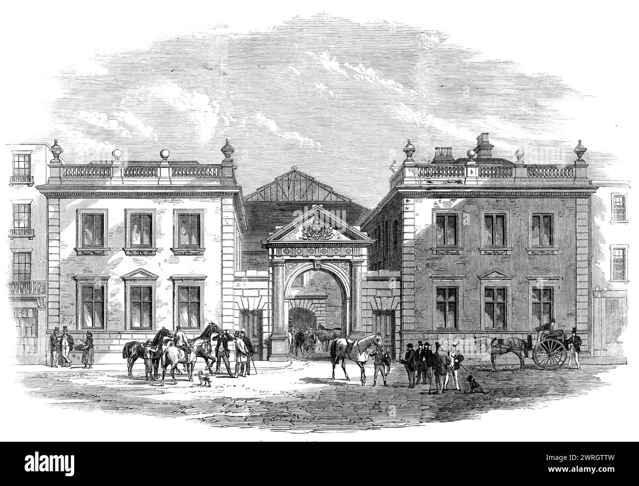 Il nuovo "Tattersall's" a Knightsbridge-Green, [Londra], 1864. Banditore di cavalli da corsa. "La parte anteriore mostra un ingresso centrale, con frontoni splendidamente scolpiti, e due ingressi laterali; le ali sono costituite da due blocchi quadrati di mattoni gialli con tende in pietra Portland, forate con sei finestre sui due piani, e sormontate da parapetti in pietra con terminali a sfera. Il blocco di sinistra è dedicato agli abbonati; il lato destro agli uffici del segretario, ai dipartimenti commerciali, alle cabine di cablaggio [ecc]...al sud-ovest è un'area...per le scommesse all'aperto, con un ufficio telegrafico. Foto Stock