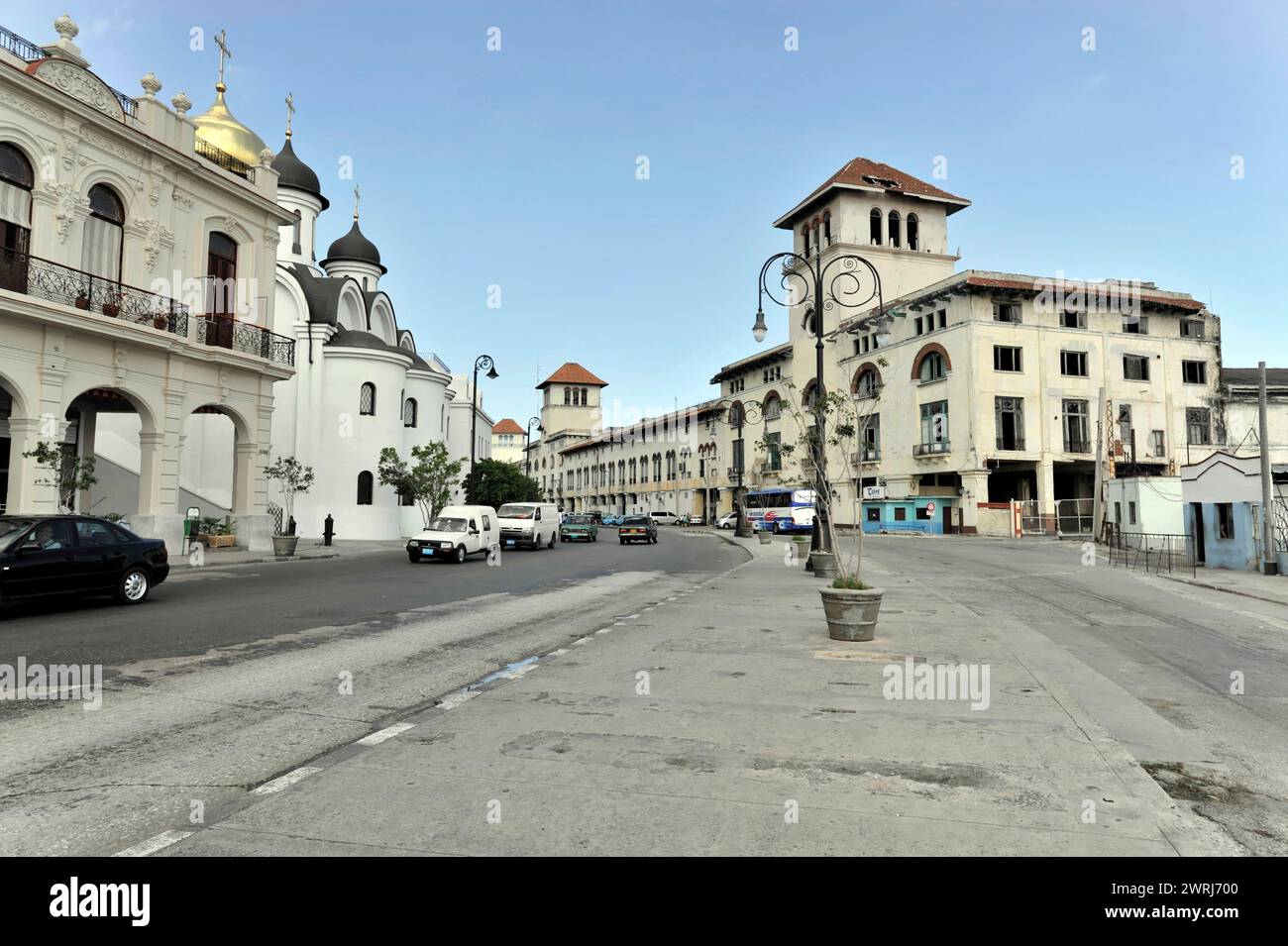 Ampia strada con auto e architettura impressionante sotto un cielo blu, l'Avana, Cuba, America centrale Foto Stock