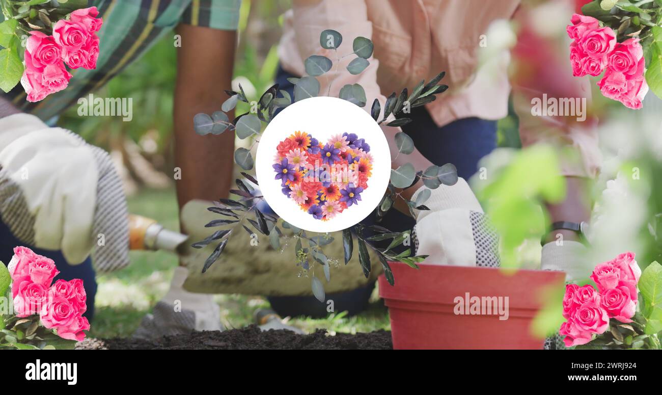 Immagine del cuore di fiori in forma rotonda sopra la figlia e il padre adulti afroamericani Foto Stock