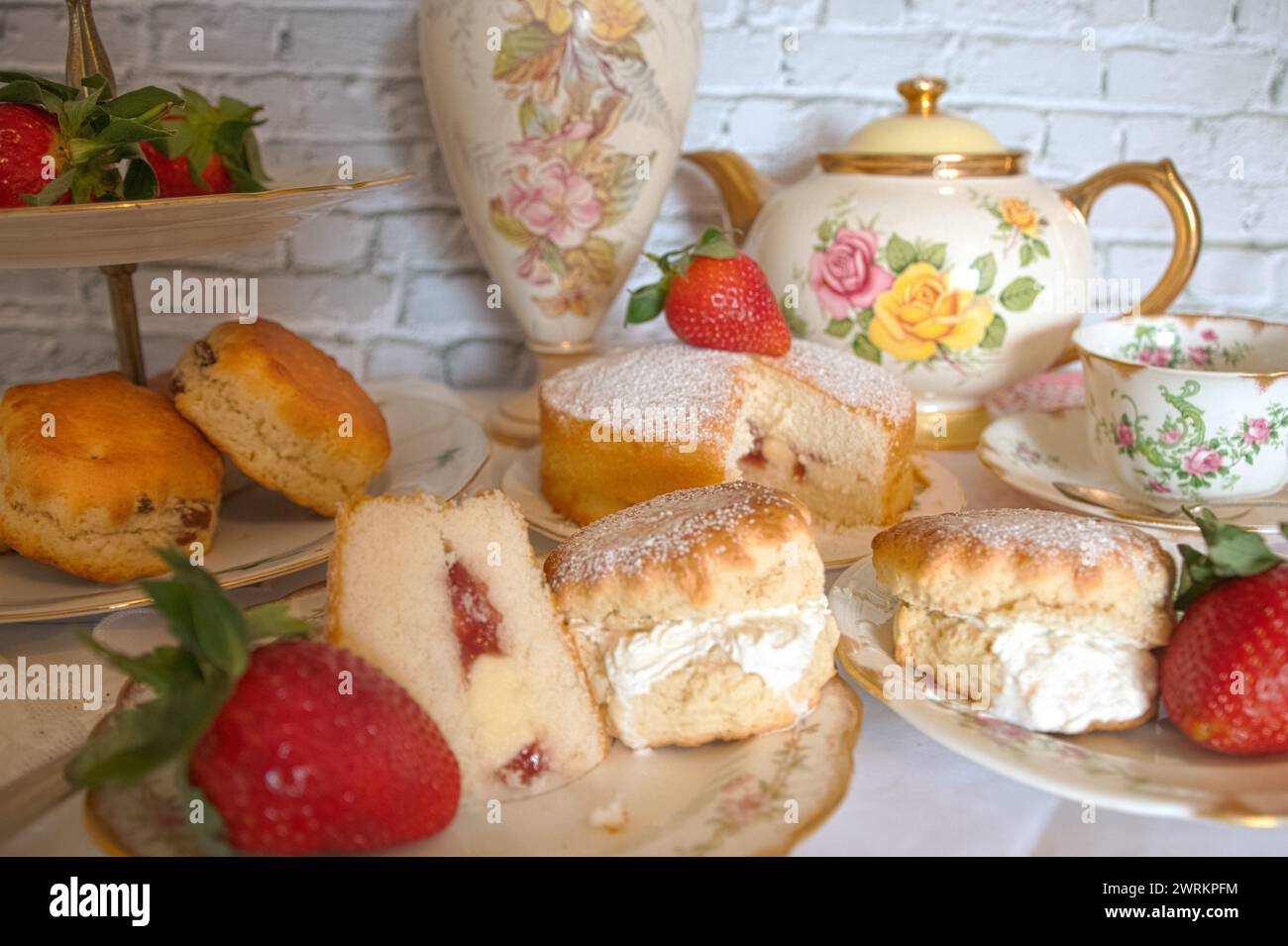 Tè pomeridiano in stile vintage, fragole e focaccine tradizionali con crema Victoria Sponge Foto Stock