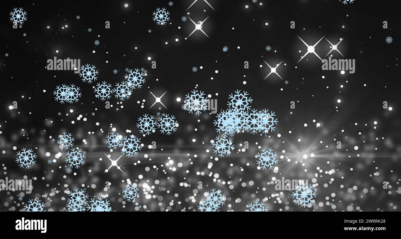 Immagine di fiocchi di neve su macchie chiare su sfondo nero Foto Stock