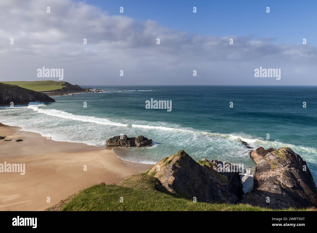 Una vista mozzafiato di Durness Beach, dove il selvaggio Atlantico bacia le coste settentrionali della Scozia, creando un tranquillo paesaggio di scogliere e sabbia Foto Stock