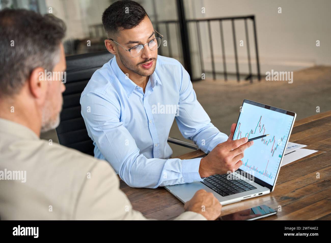 Consulente finanziario che spiega i dati del mercato azionario Invest consultando un investitore. Foto Stock