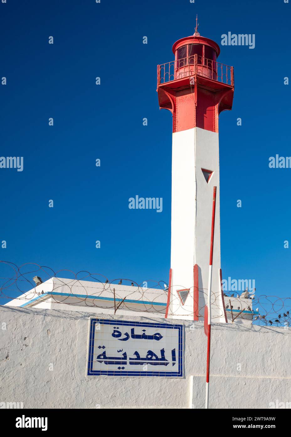 Faro di Mahdia al crepuscolo sul Capo Africa a Borg Errass, Mahdia, Tunisia. L'insegna araba recita: Faro di Mahdia Foto Stock