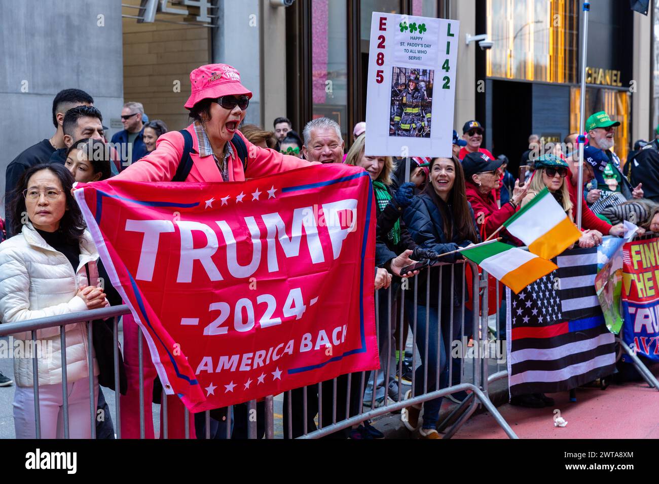 New York, New York, Stati Uniti. 16 marzo 2024. Contingenti irlandesi-americani hanno preso il via dalla St. Di New York Patrick's Day Parade con le melodie di numerose bande di pipe e applaudito da schiere di spettatori, molti addobbati di verde. Sostenitori di Trump dall'altra parte della Fifth Avenue dagli striscioni a onda della Trump Tower. Crediti: Ed Lefkowicz/Alamy Live News Foto Stock