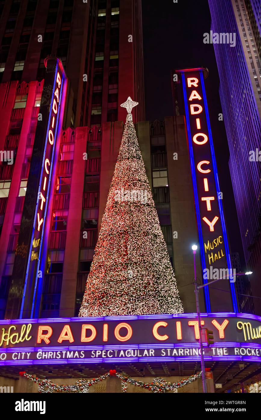 Un enorme albero di Natale di fronte al radio City Music Hall di notte, illuminato e festoso, Manhattan, New York City, New York, Stati Uniti, Nord America Foto Stock
