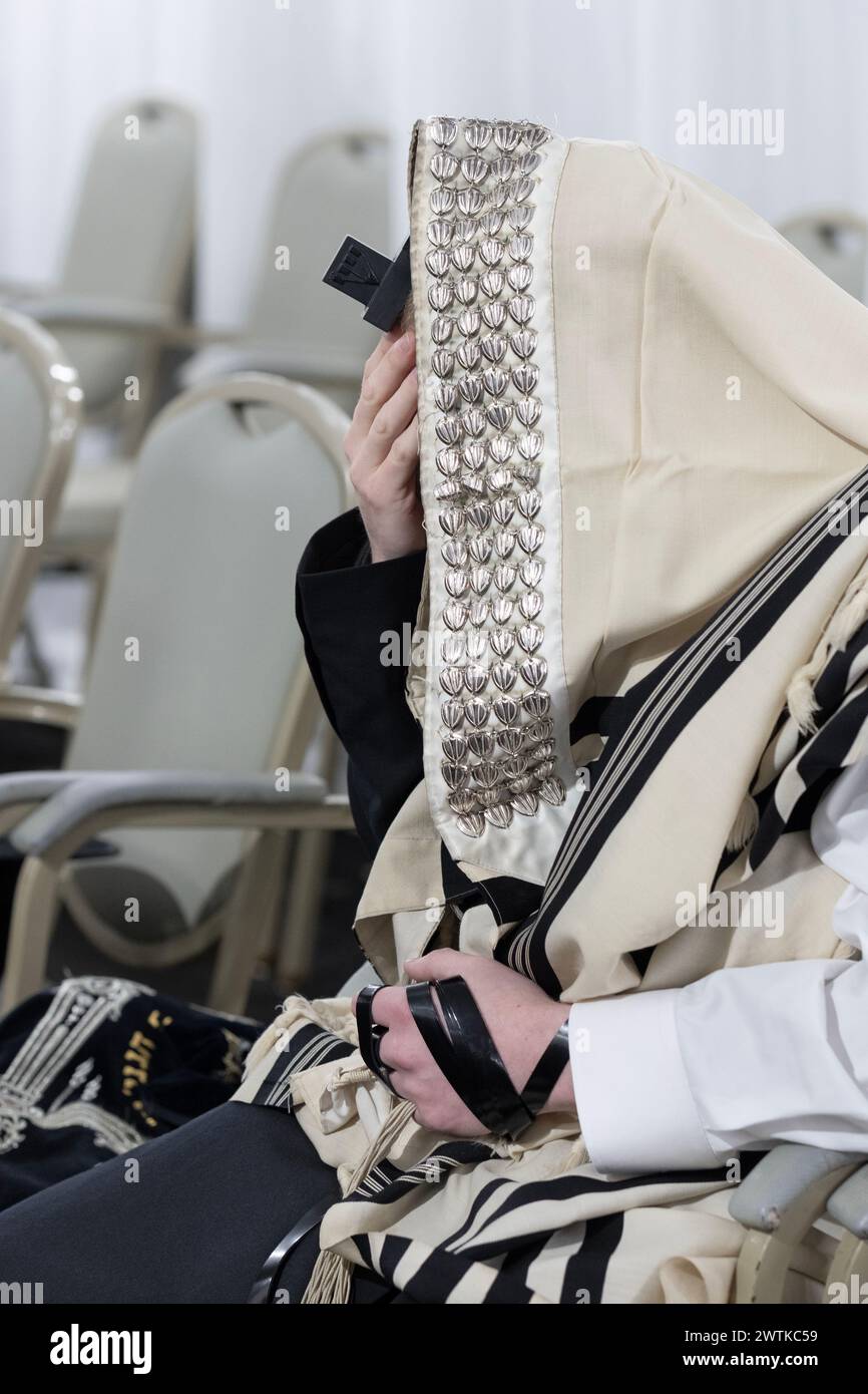 Un devoto ebreo chassidico che indossa un tallis & tefillin prega in una sinagoga nella Contea di Rockland, Neew York. Foto Stock