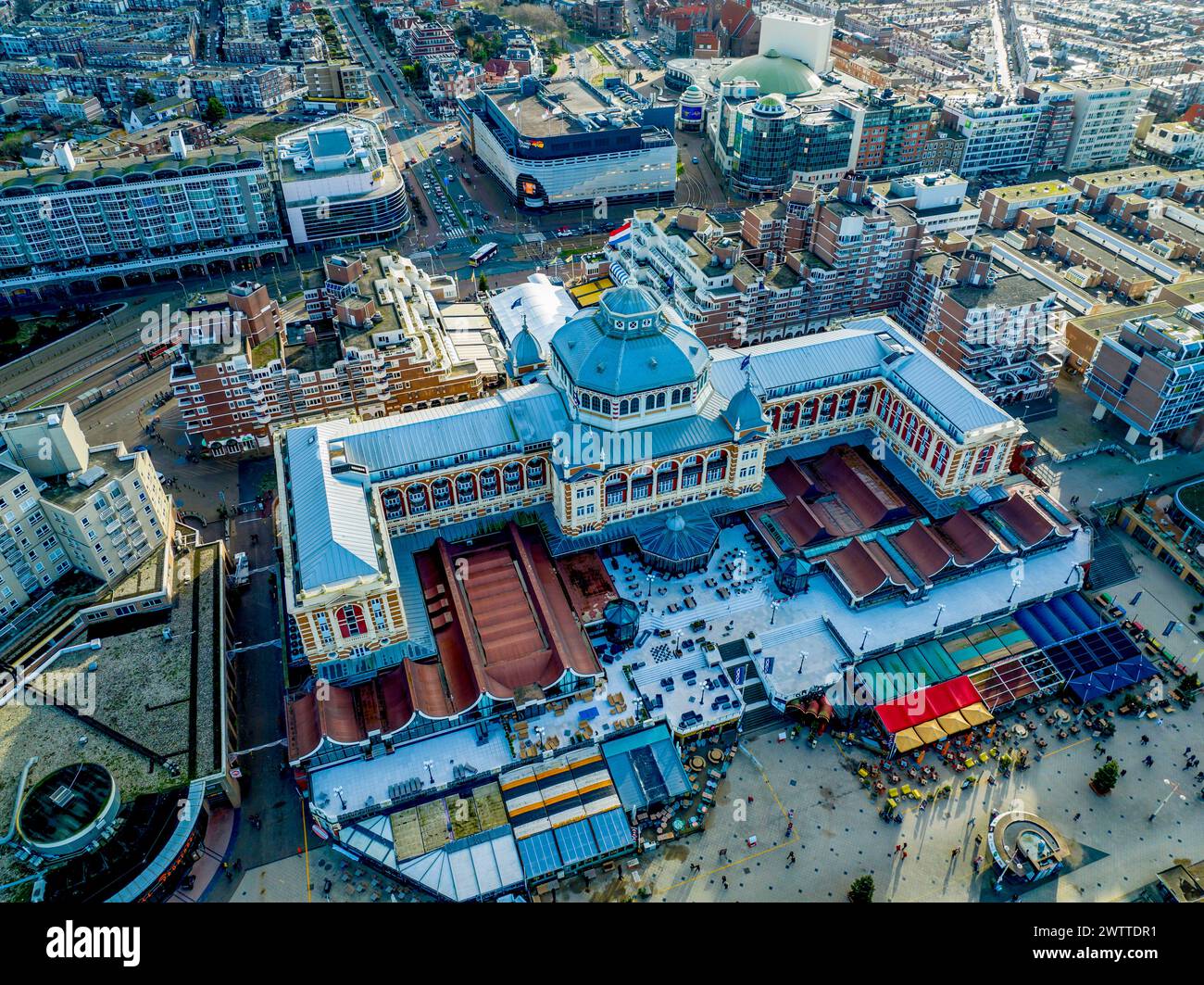 Vista aerea di un edificio storico con un impressionante tetto blu in un paesaggio urbano moderno in una giornata di sole. Foto Stock