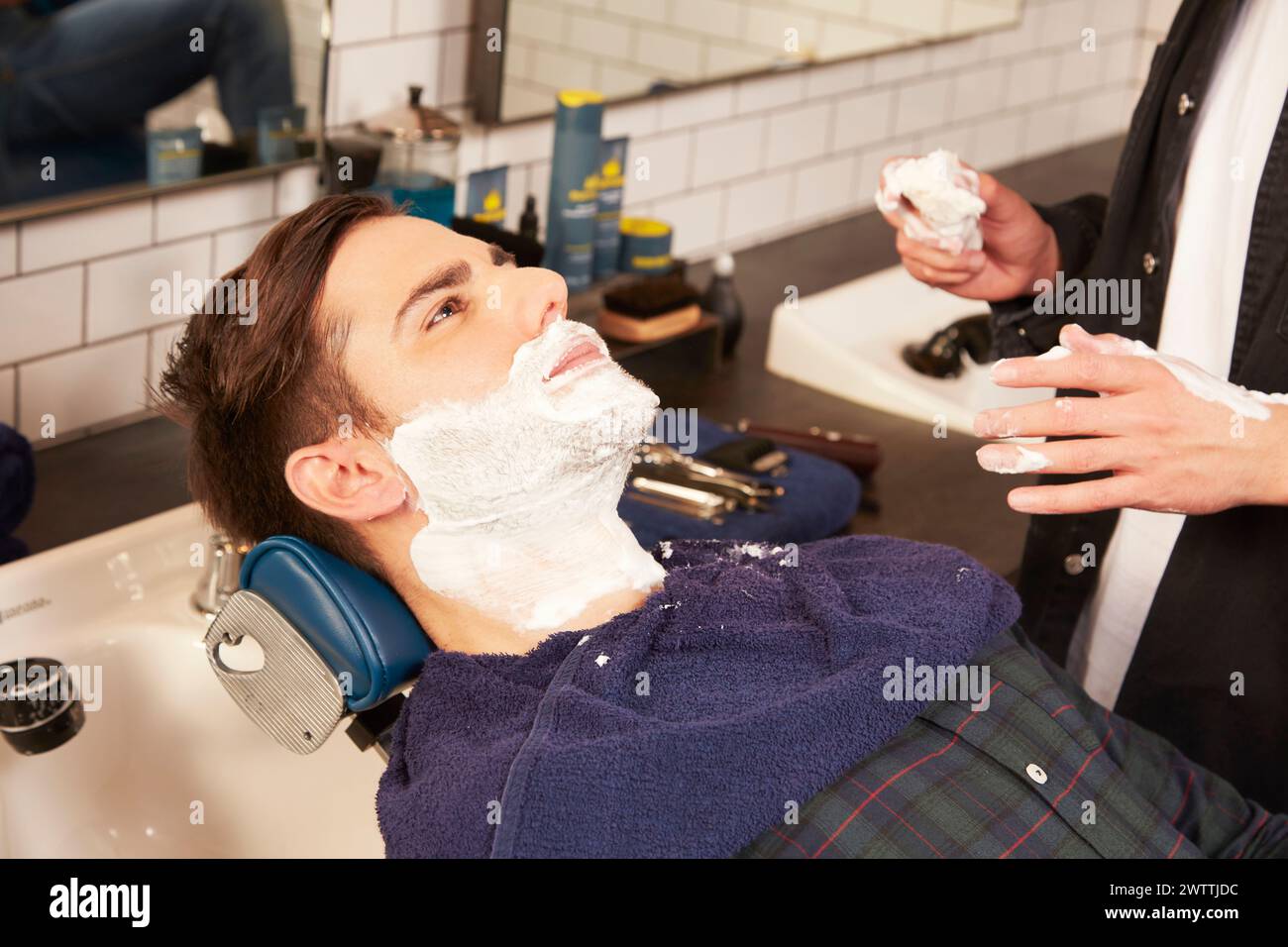 Uomo che si rade in un barbiere Foto Stock