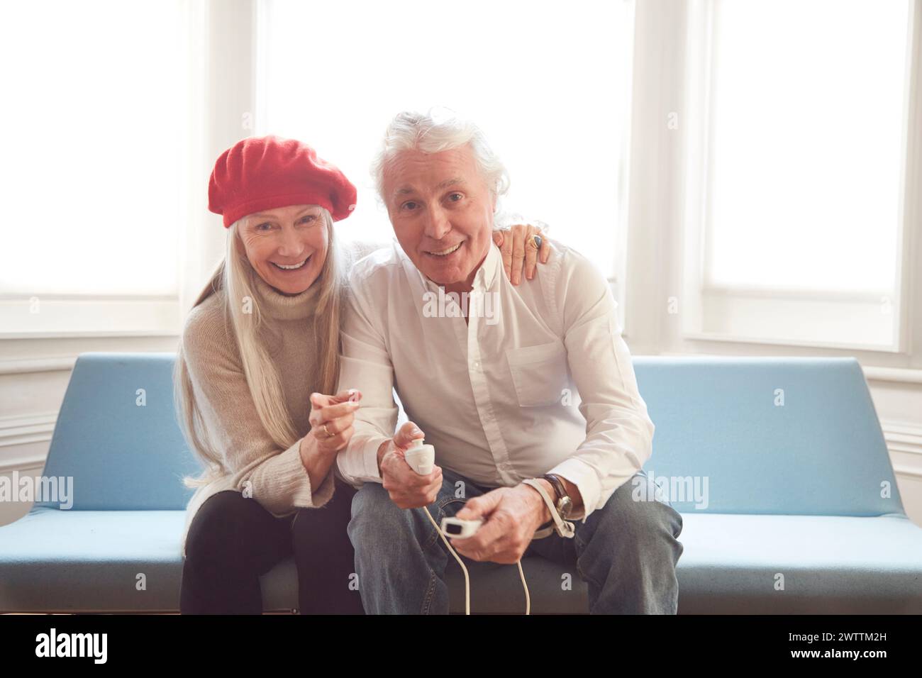Due persone sorridenti e in mano un controller di gioco Foto Stock