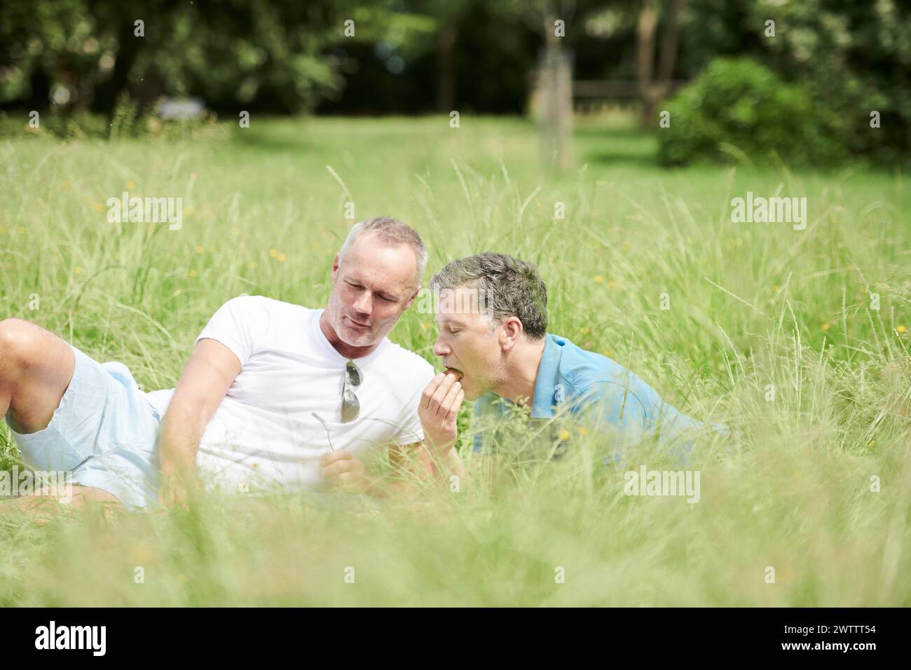 Due persone che si rilassano in un campo erboso Foto Stock
