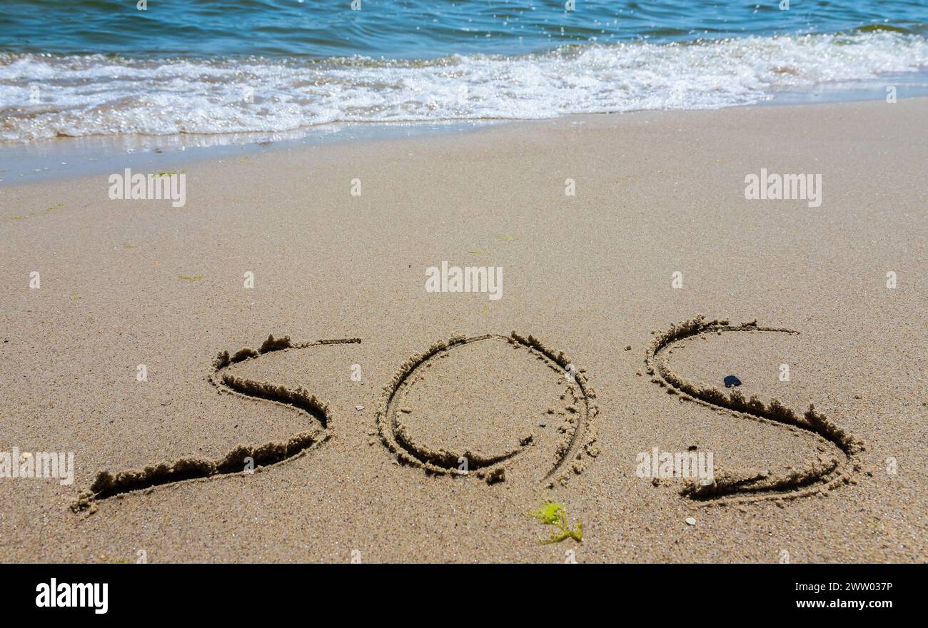 L'iscrizione sulla sabbia alla spiaggia sos. Foto Stock