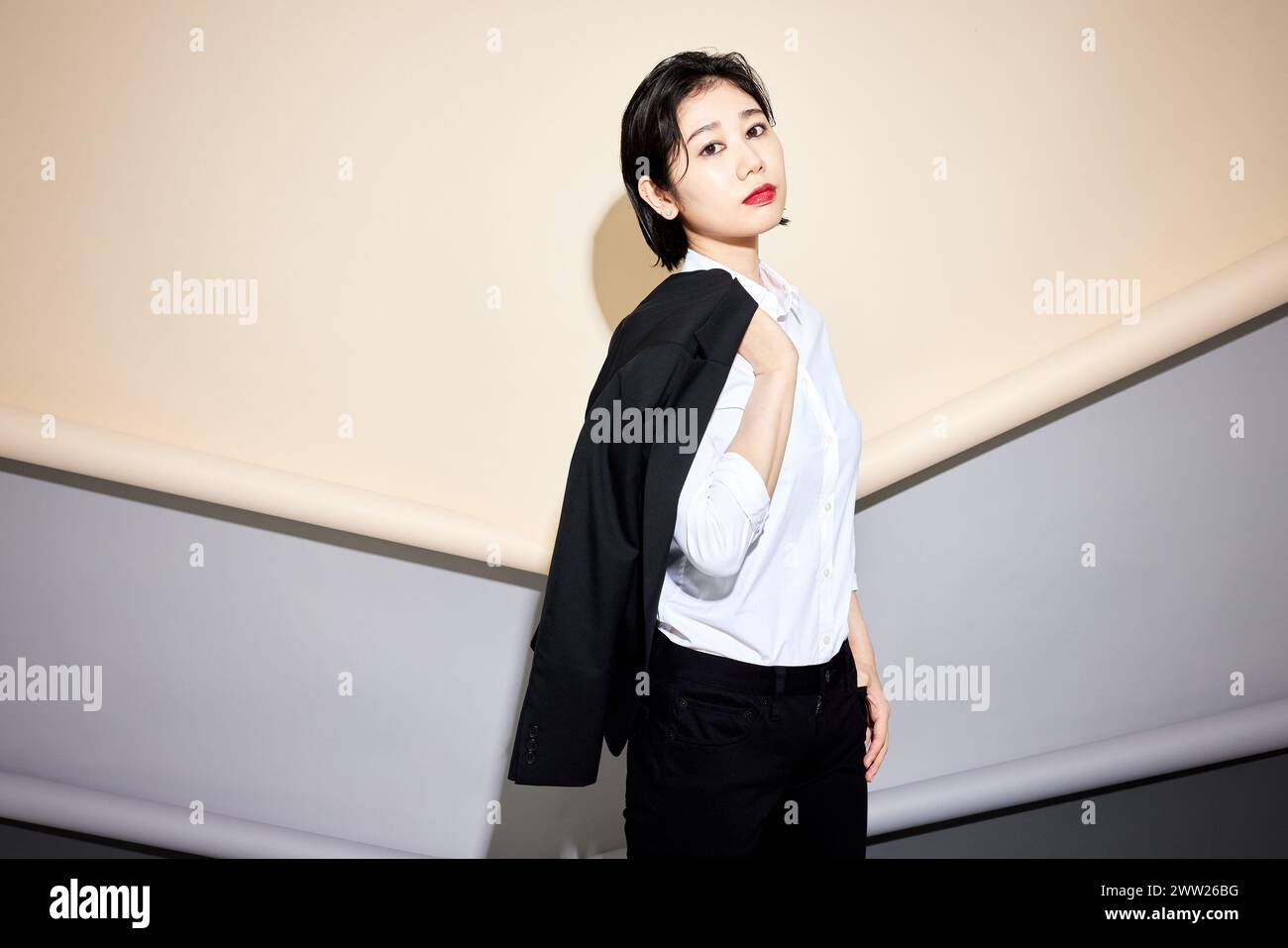 Una donna in camicia bianca e pantaloni neri Foto Stock