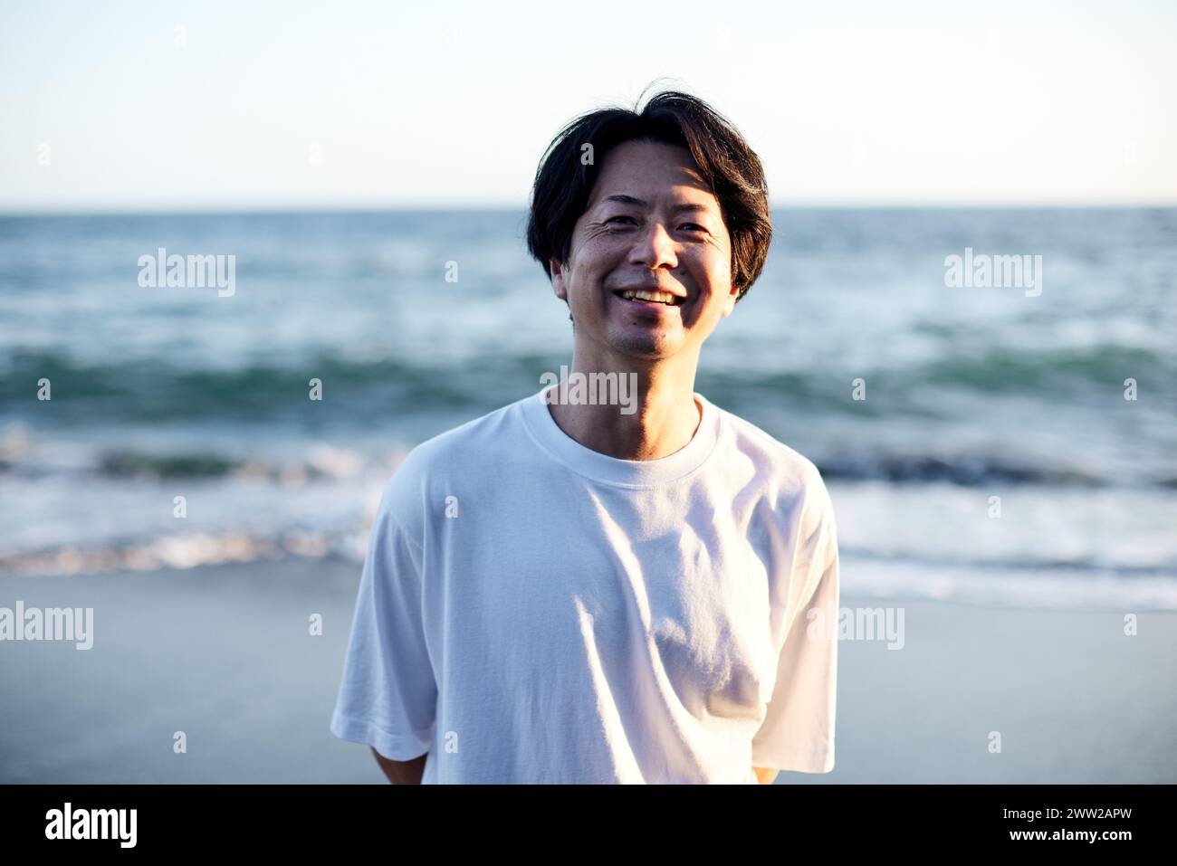 Un uomo in piedi sulla spiaggia Foto Stock