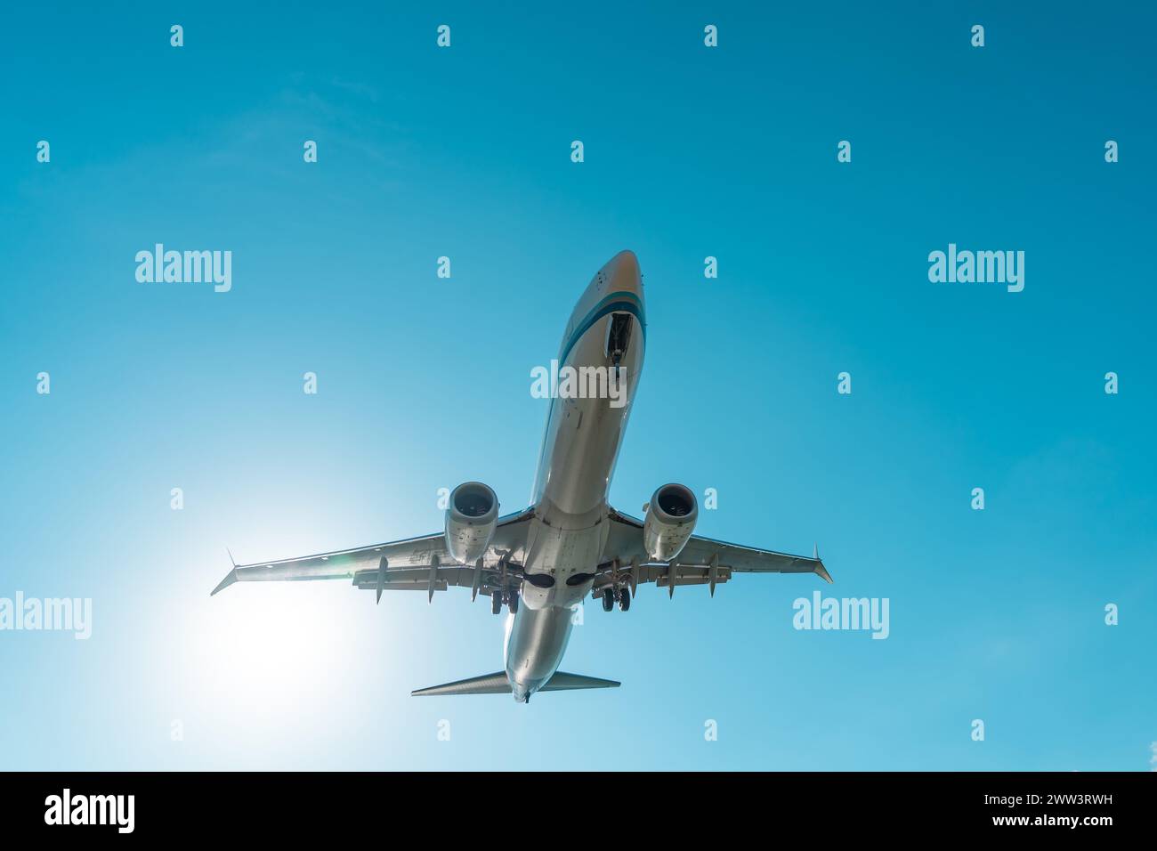 Aeroplano nel cielo soleggiato in avvicinamento all'atterraggio Foto Stock