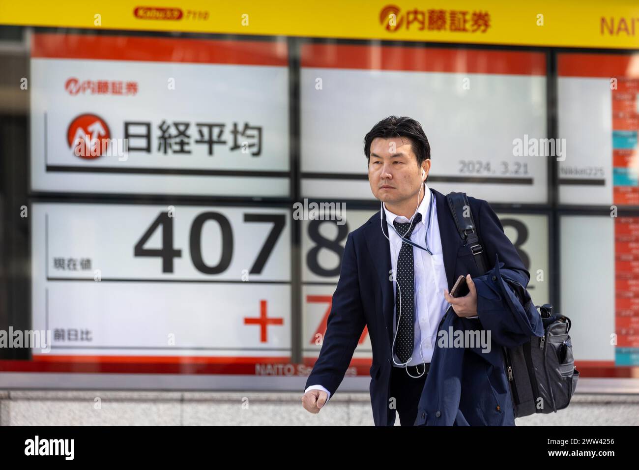 Tokyo, Giappone. 21 marzo 2024. I membri del pubblico passeranno davanti all'esposizione che mostra la media delle azioni Nikkei nel quartiere finanziario di Tokyo. Crediti: Marcin Nowak/Alamy Live News Foto Stock