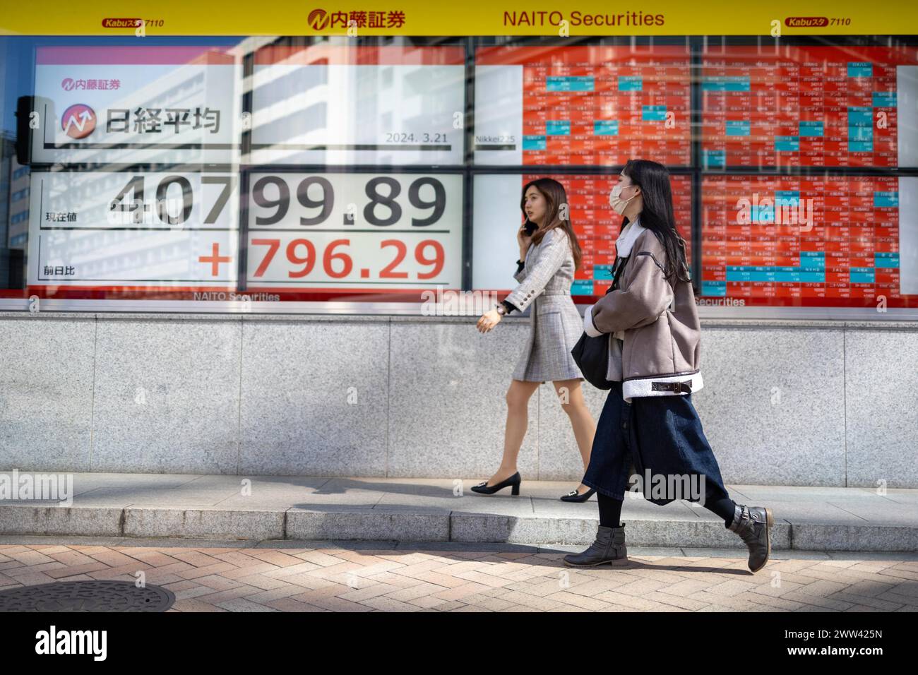 Tokyo, Giappone. 21 marzo 2024. I membri del pubblico passeranno davanti all'esposizione che mostra la media delle azioni Nikkei nel quartiere finanziario di Tokyo. Crediti: Marcin Nowak/Alamy Live News Foto Stock
