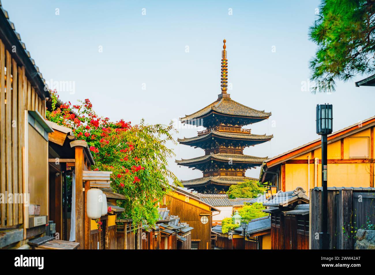 Pittoresche Antica Pagoda Peaks nella storica via giapponese fiancheggiata da fiori Foto Stock