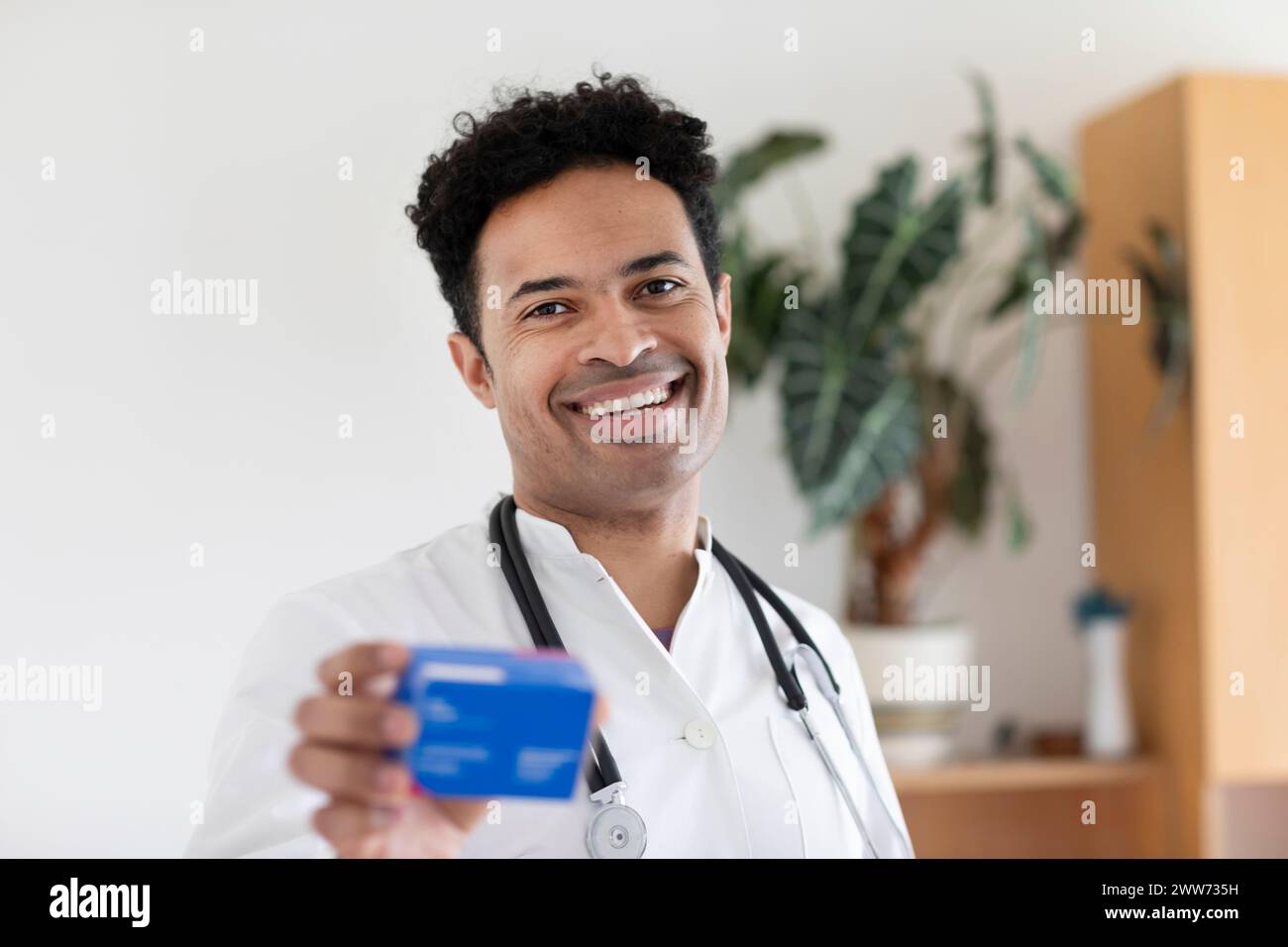 medico, uomo, razza mista in uno studio Foto Stock