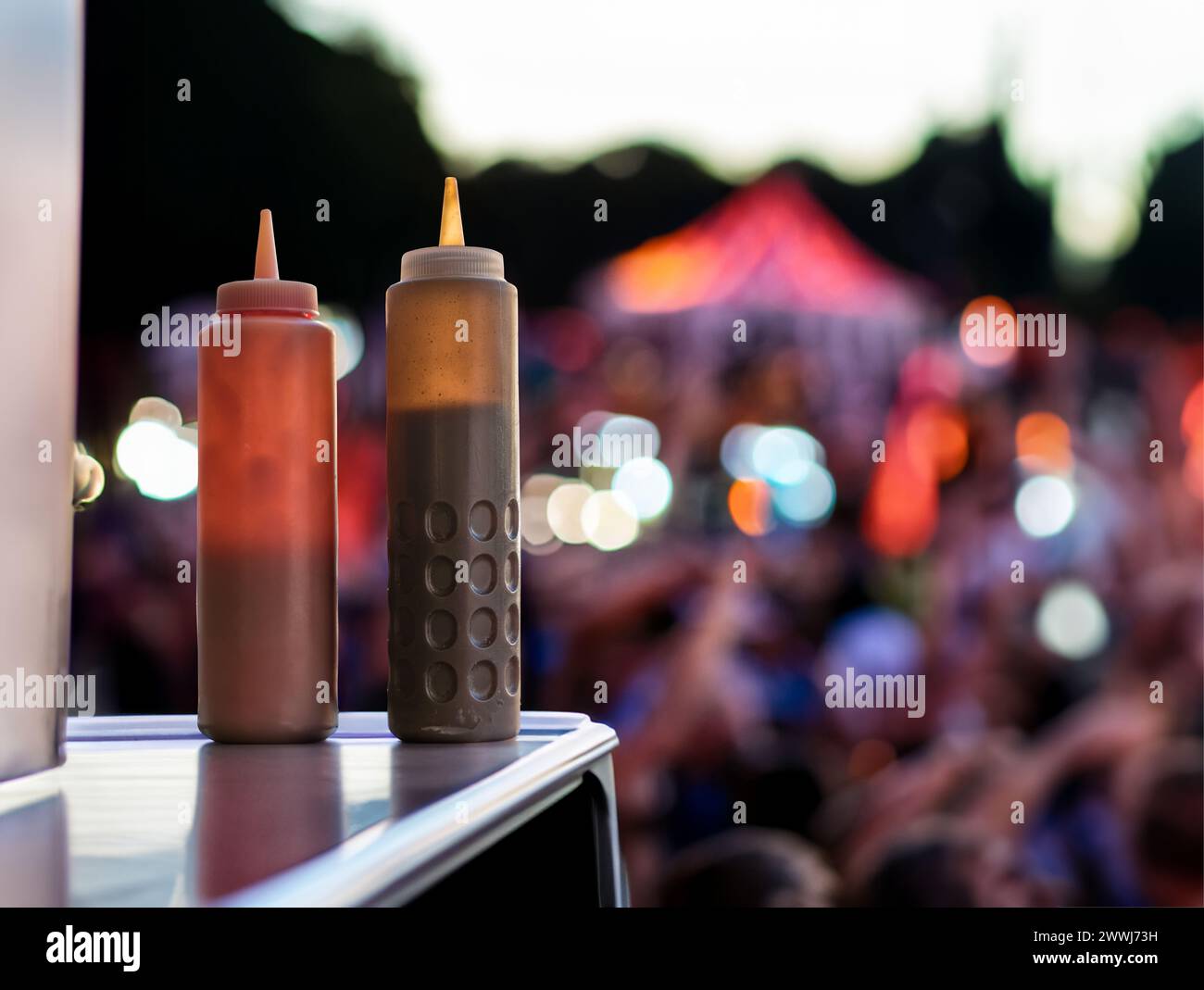 Una coppia di bottiglie Squeezy a Un Food Truck a Un festival musicale o a un concerto al Dusk, con Copy Space Foto Stock