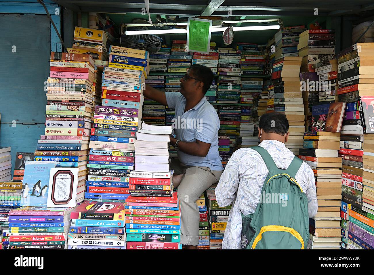 Una banchina all'aperto piena di guide agli esami, libri di testo e romanzi in brossura lungo College Street, Kolkata Foto Stock