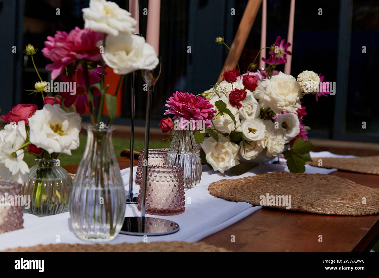 Decorazioni floreali fresche per feste all'aperto. Concetto di guide all'organizzazione di feste in giardino e matrimoni. Foto Stock