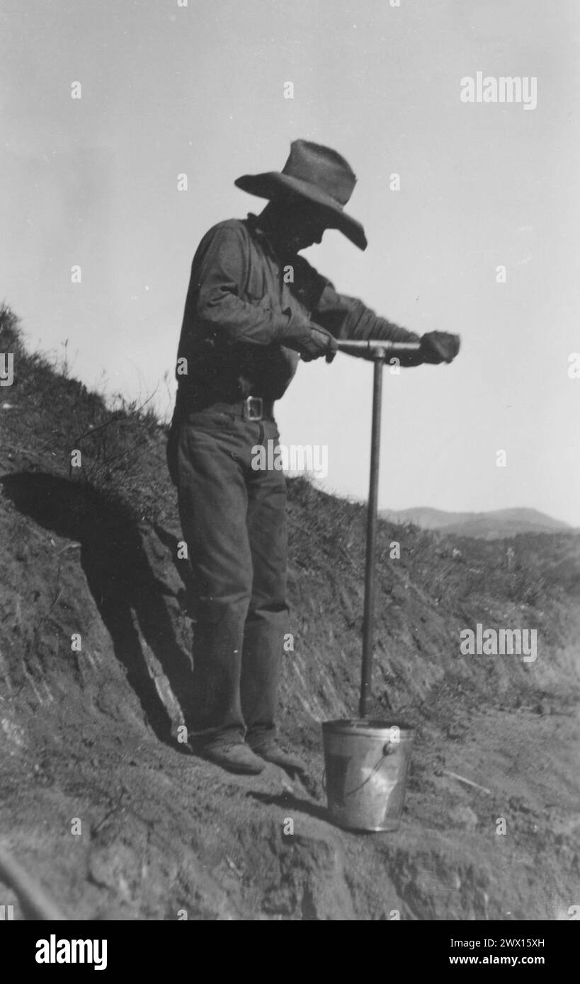 Mesa grande Band of Diegueno Mission Indians, California: Photograph of Worker Drilling with Auger in Soft Decomposed Granite on Truck Trail at Mesa grande CA. 1936-1942 Foto Stock