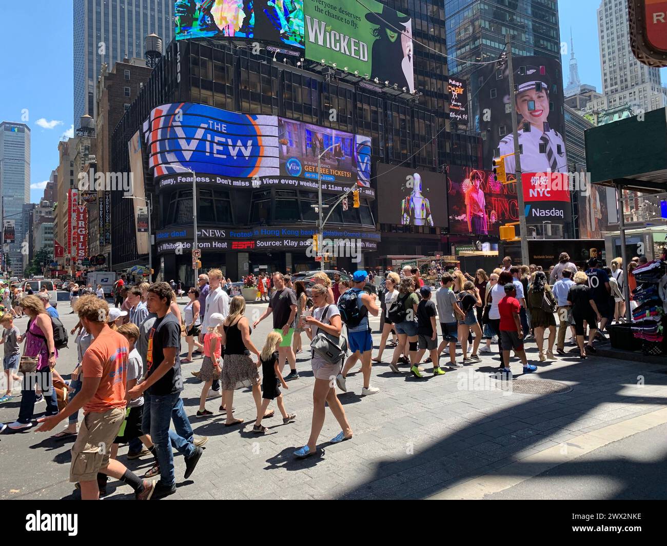 I pedoni affollano l'incrocio entrando all'incrocio di Times Square a New York Foto Stock
