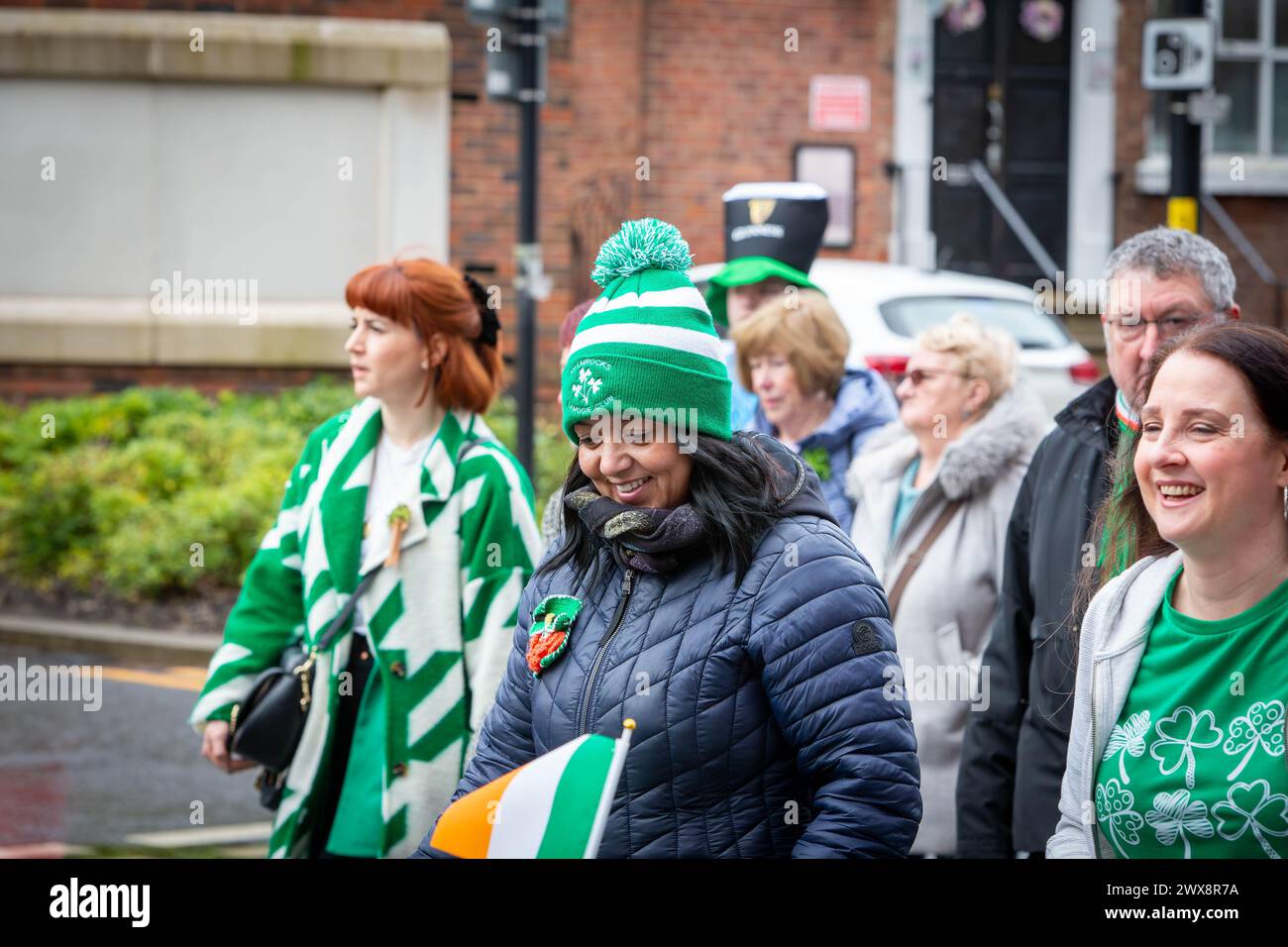 Lady nella sfilata del giorno di San Patrizio del 2024 di Warrington con indosso un cappello in lana Shamrock Camogie Club Foto Stock