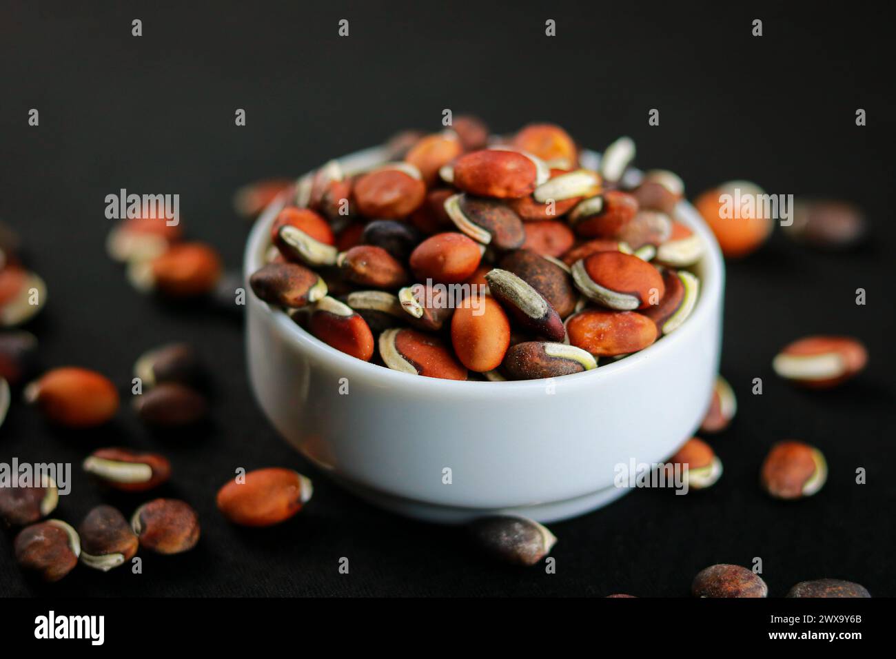 Primo piano di fagioli in un recipiente su sfondo nero Foto Stock