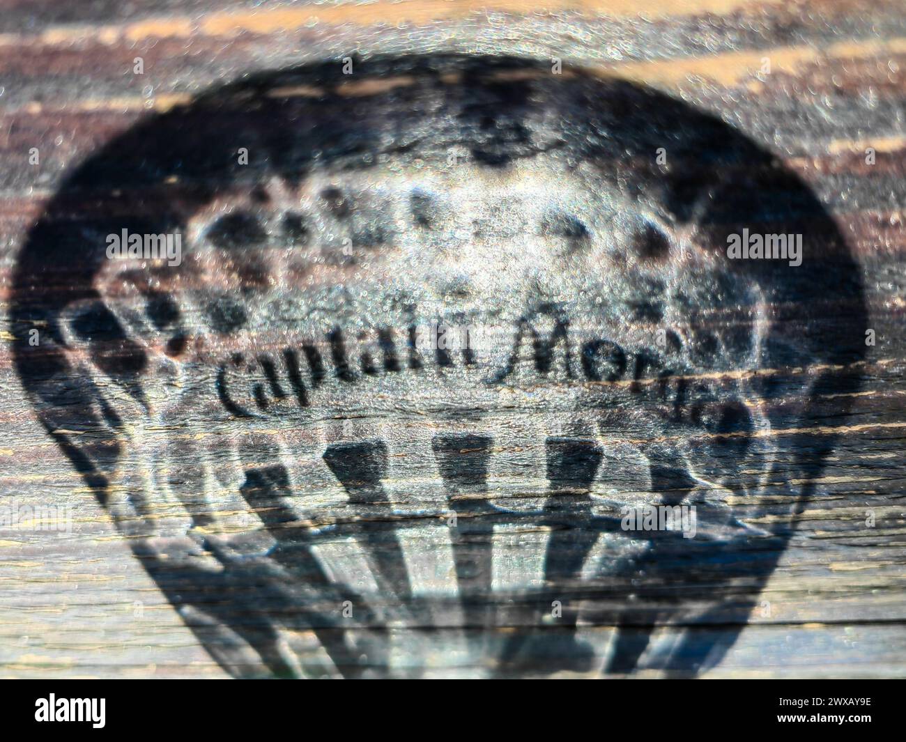 Echi effimeri. Logo del rum Captain Morgan in ombra su un tavolo in legno intemprato. 3. 29. 2024 Shtip Macedonia Foto Stock