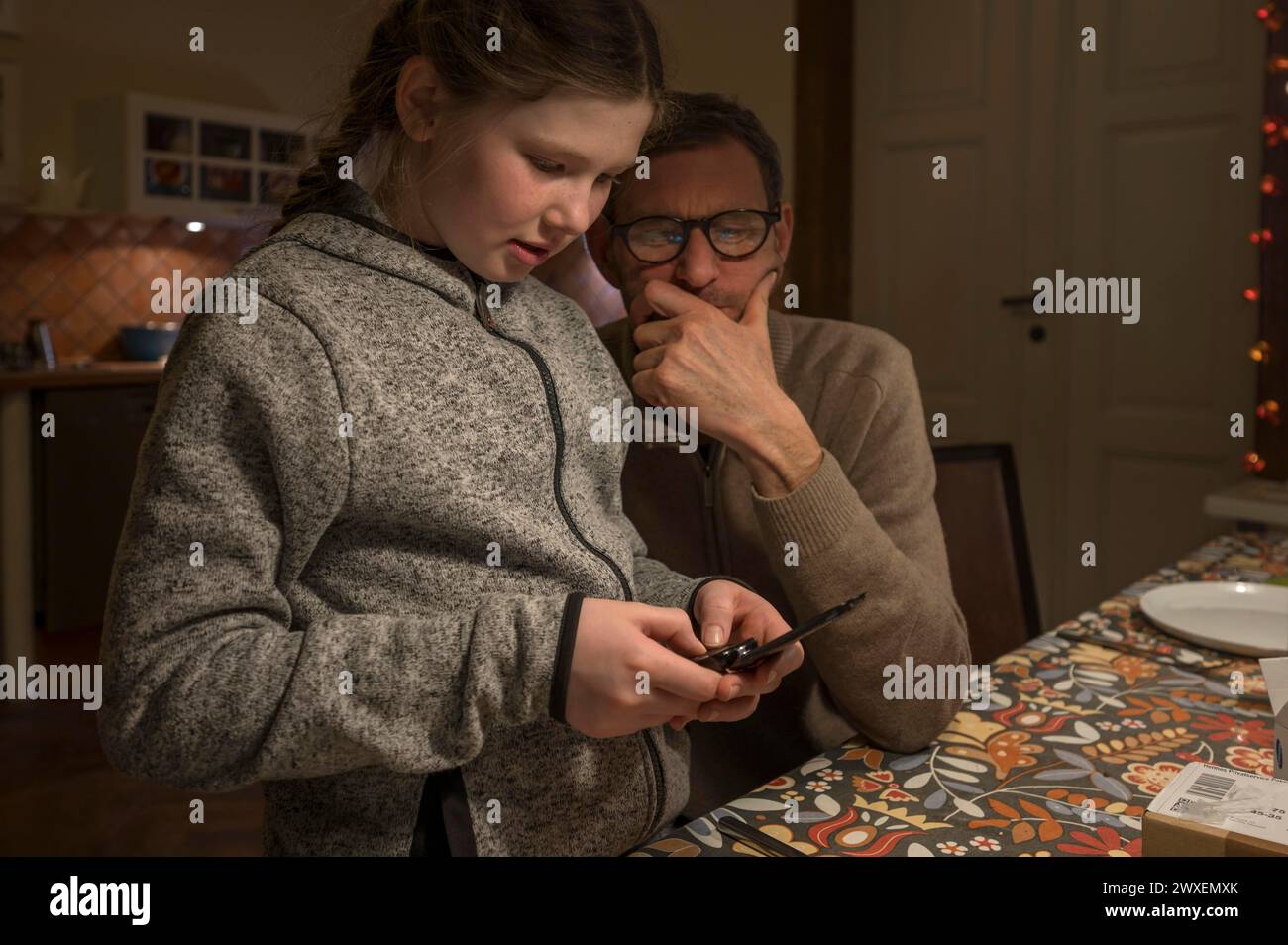 Padre e figlia in cerca di qualcosa con il loro cellulare, Meclemburgo-Vorpommern, Germania Foto Stock