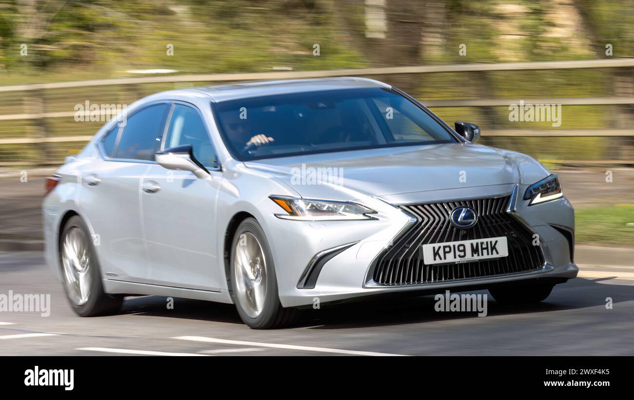 Milton Keynes, UK-30 marzo 2024:2019 auto elettrica ibrida Lexus ES 300H argento che guida su una strada britannica Foto Stock