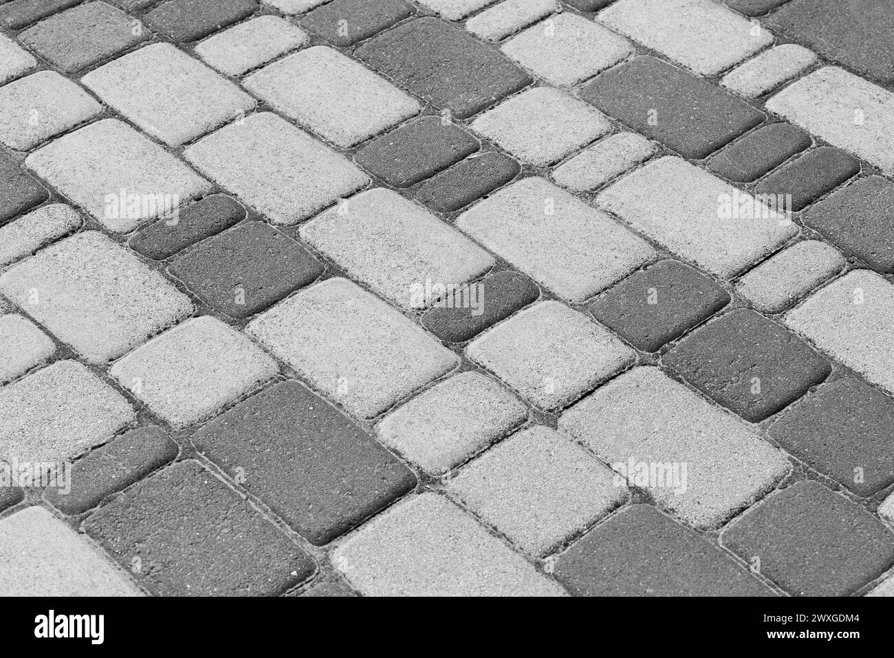 Pavimentazione scura e grigia pavimento in pietra piastrelle Street Pattern texture sfondo Mosaico Urban Road. Foto Stock