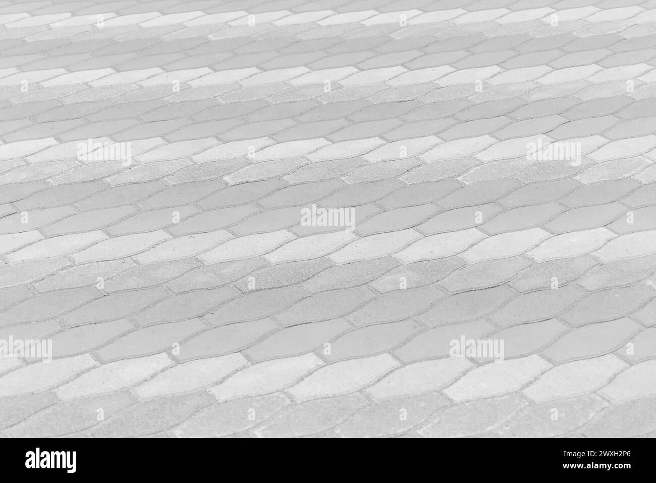 Linee chiare e luminose strisce pavimentazione superficie in pietra strada strada città texture sfondo piastrelle. Foto Stock