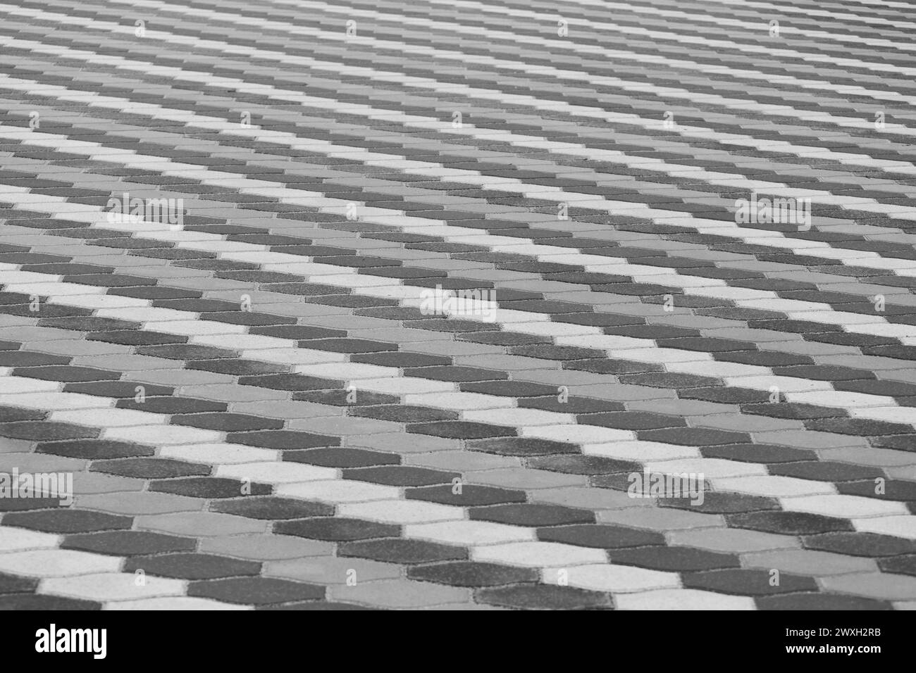 Linee con motivo grigio strisce pavimentazione in pietra superficie strada strada città tessitura sfondo piastrelle. Foto Stock