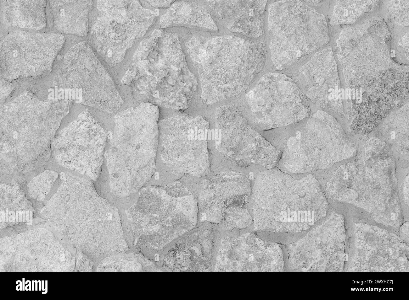 Struttura in pietra grigio chiaro superficie ruvida del pavimento motivo astratto piastrella di sfondo pieno sfondo grezzo bianco. Foto Stock