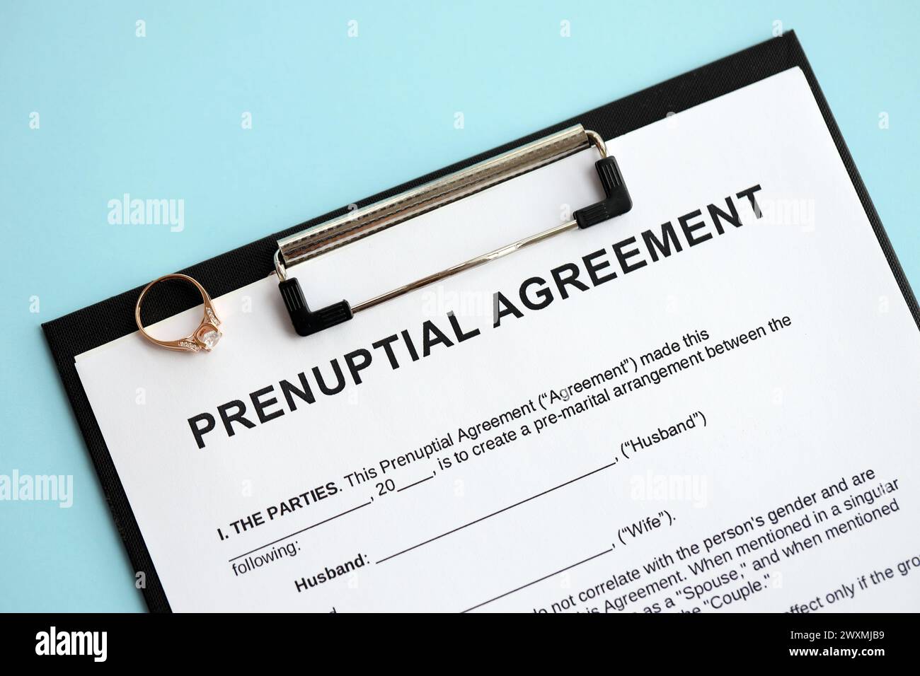 Accordo prematrimoniale e fede nuziale sul tavolo. Primo piano del processo di documentazione prematrimoniale Foto Stock
